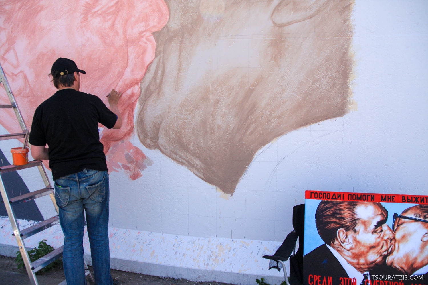 repainting the Berlin wall years after its fall. berlin
